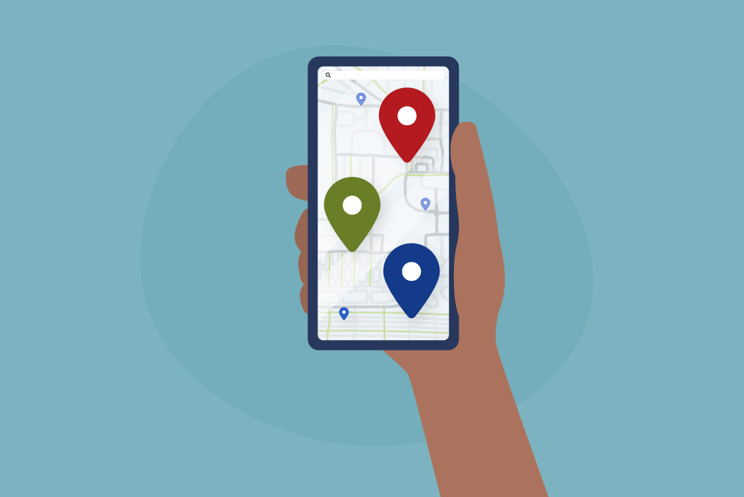 hand holding phone with map markers on screen