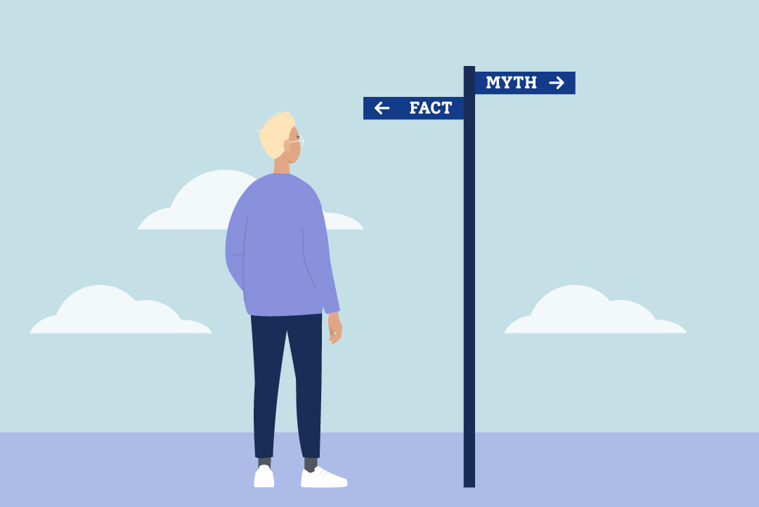 person reading a way-finding sign that points in directions to "myth" and "fact"