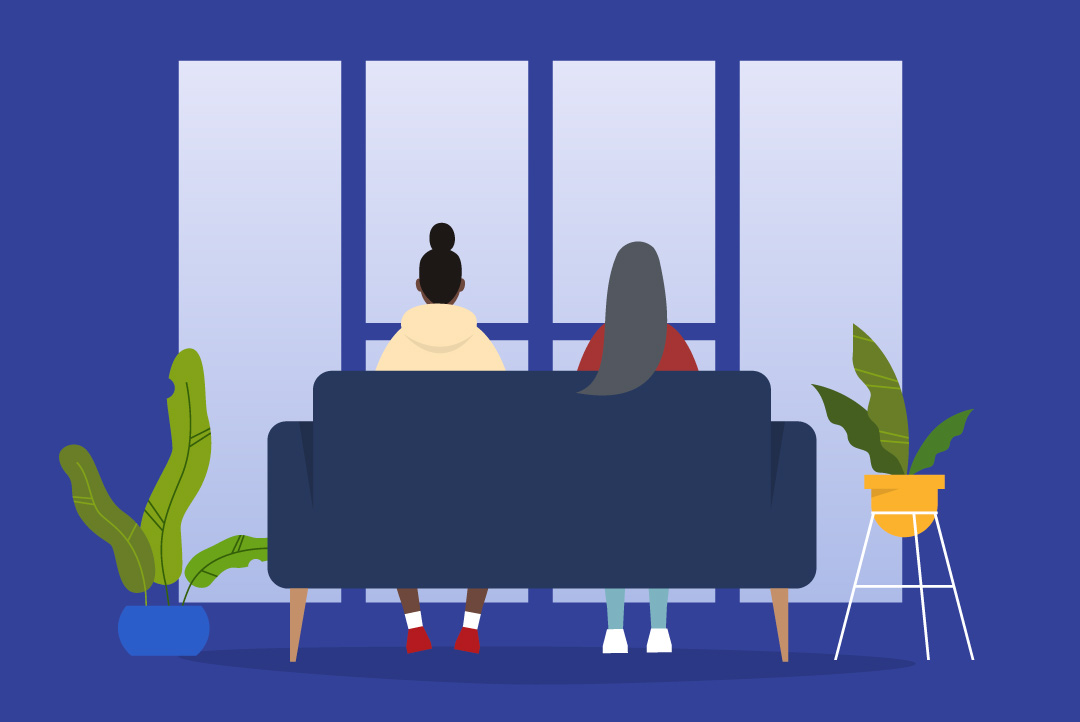 two people sitting on a couch facing the window