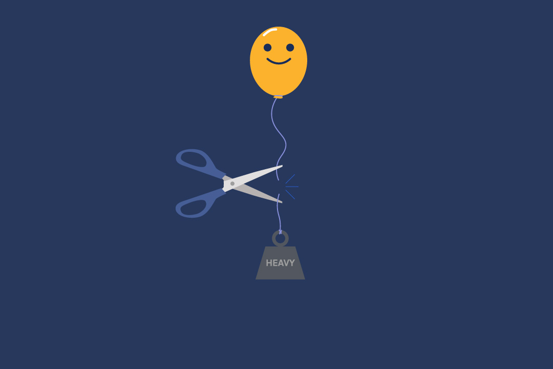 scissors cutting a ribbon where a weight is holding down a happy face balloon