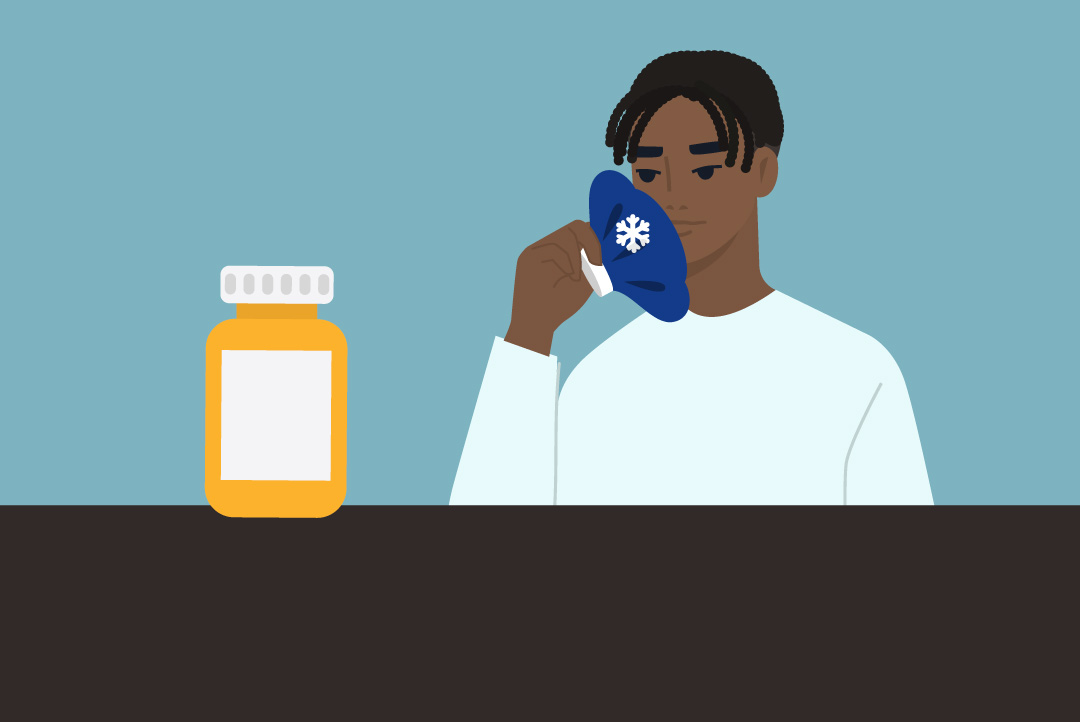 person icing jaw, looking at pill bottle