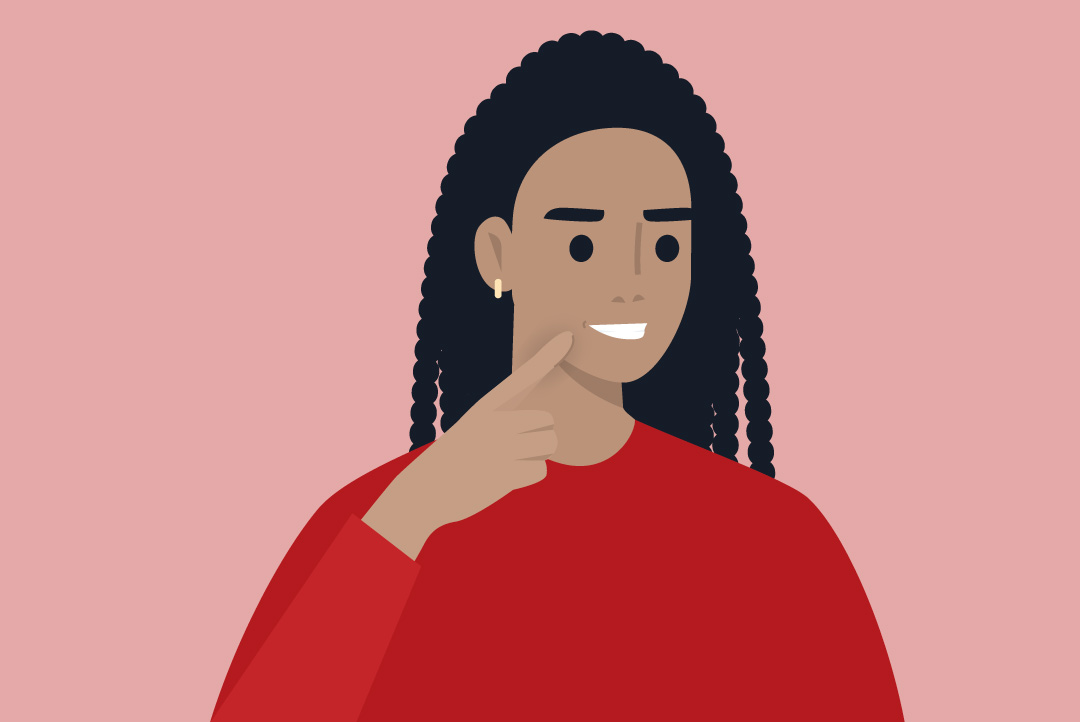 person pointing to beautiful, healthy smile