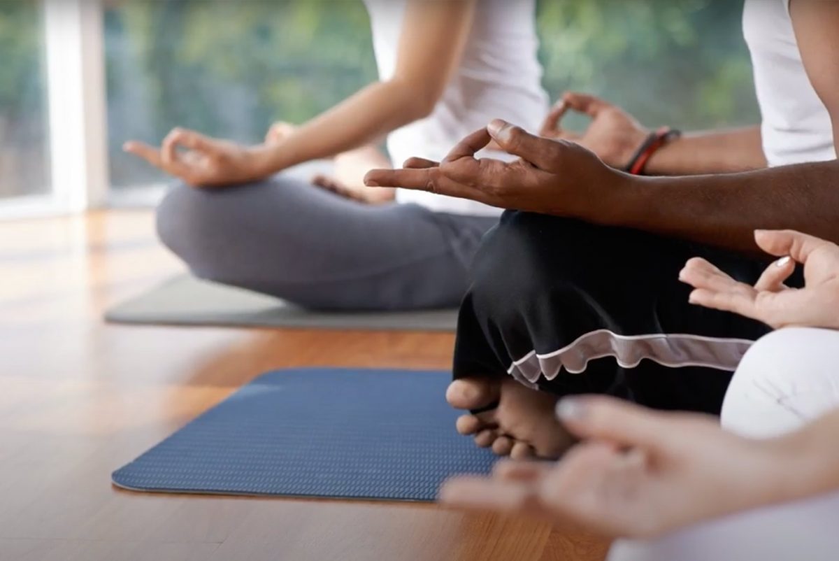 group of people meditating in yoga studio