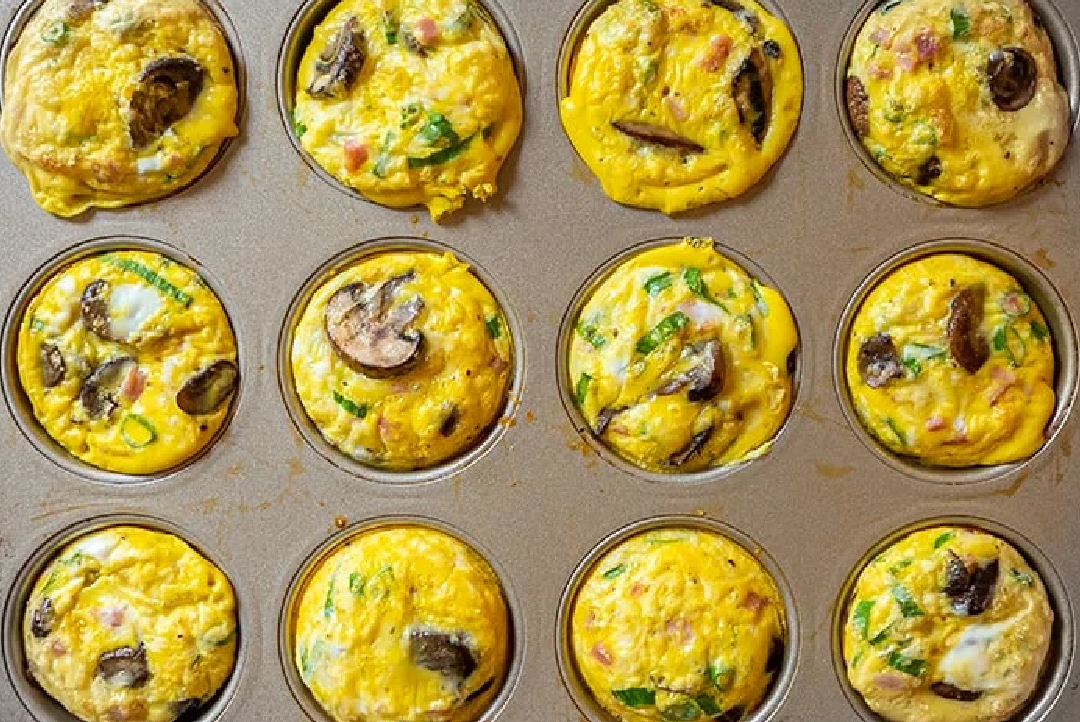 Photo of ham & Swiss frittatas cooked in a muffin tin